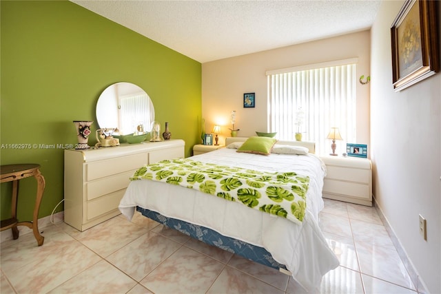 tiled bedroom featuring a textured ceiling