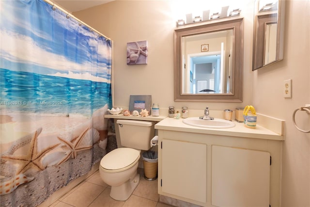 bathroom featuring walk in shower, vanity, toilet, and tile patterned floors