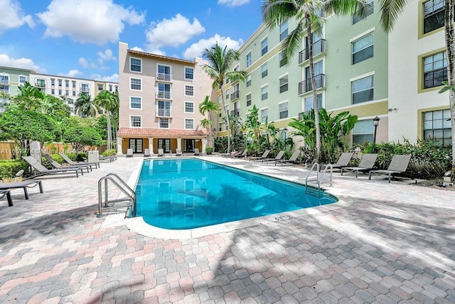 community pool with a patio area