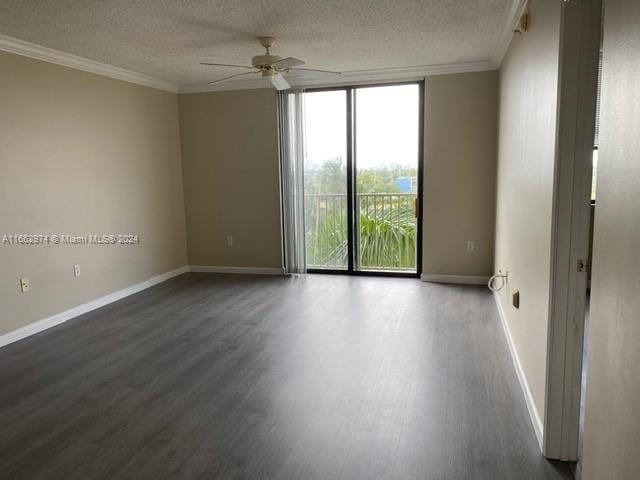 unfurnished room featuring ceiling fan, expansive windows, wood-type flooring, a textured ceiling, and crown molding