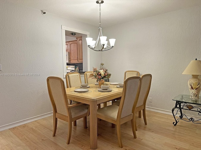 dining room featuring a notable chandelier and light hardwood / wood-style floors