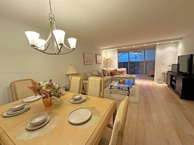 dining room featuring light hardwood / wood-style floors and a chandelier