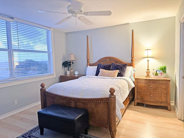 bedroom with ceiling fan and light hardwood / wood-style floors