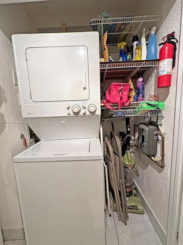 washroom with stacked washer and clothes dryer