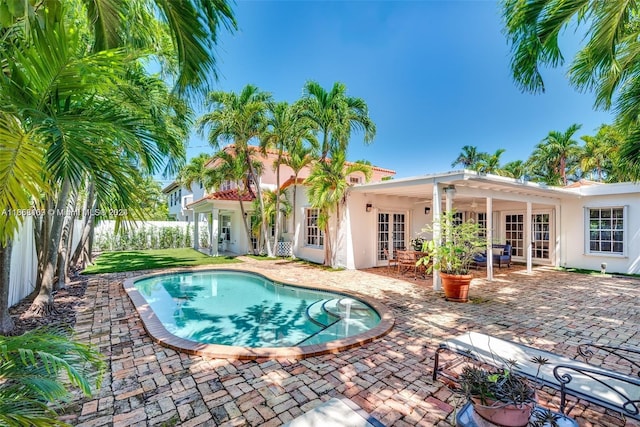 view of swimming pool featuring a patio and french doors