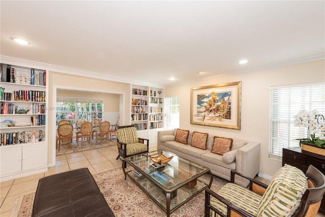 living room featuring built in shelves, light tile patterned floors, and crown molding