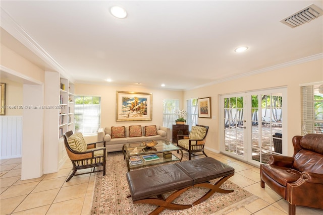 living room with french doors, crown molding, and light tile patterned floors