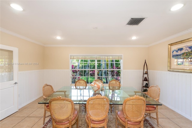 dining area featuring crown molding and light tile patterned floors