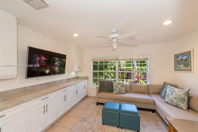 tiled living room featuring ceiling fan