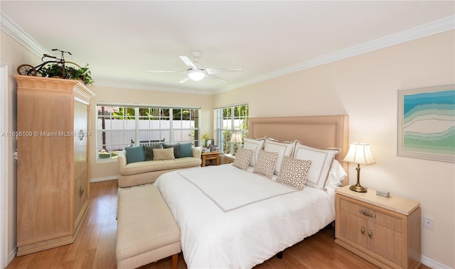 bedroom featuring light hardwood / wood-style floors, ceiling fan, and crown molding