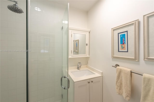 bathroom featuring vanity and a shower with shower door