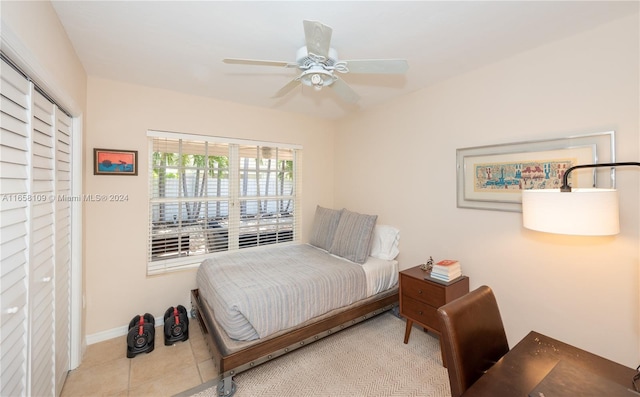 bedroom with light tile patterned floors, ceiling fan, and a closet