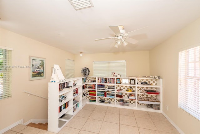 interior space featuring ceiling fan and light tile patterned floors