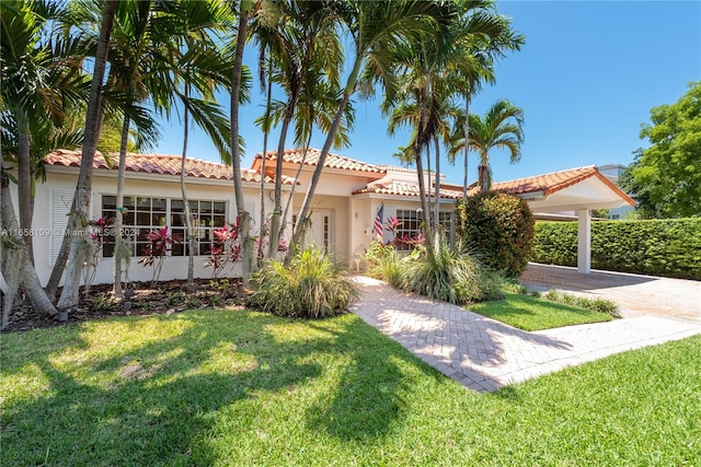 mediterranean / spanish house with a front yard and a garage