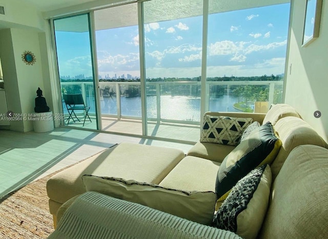 interior space with a water view, expansive windows, and visible vents