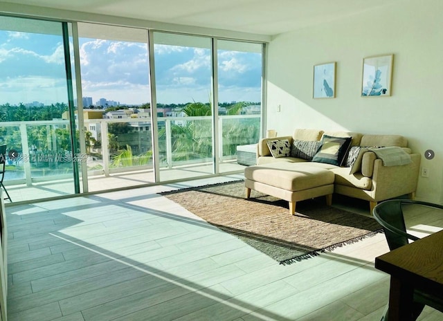 living room with expansive windows and wood finished floors