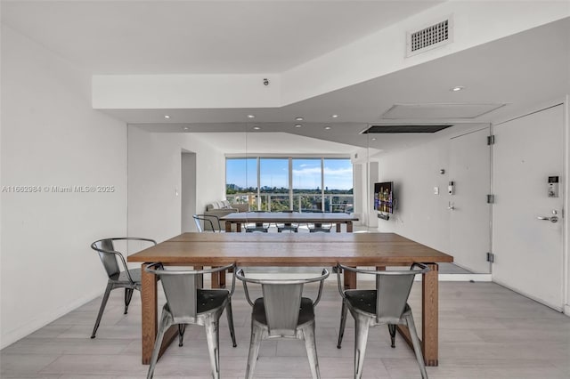 dining space featuring light wood finished floors, visible vents, and recessed lighting