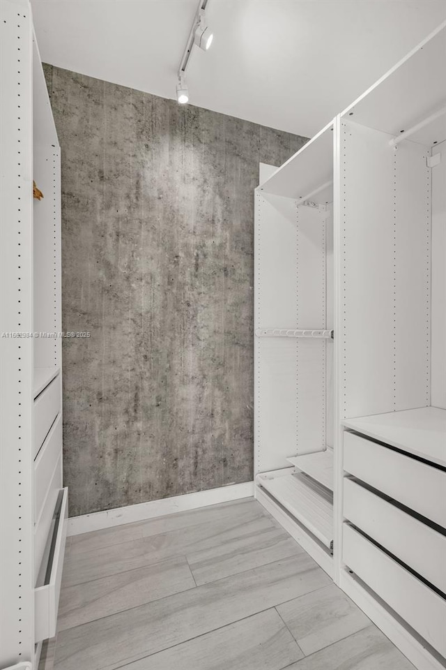 spacious closet with wood finished floors