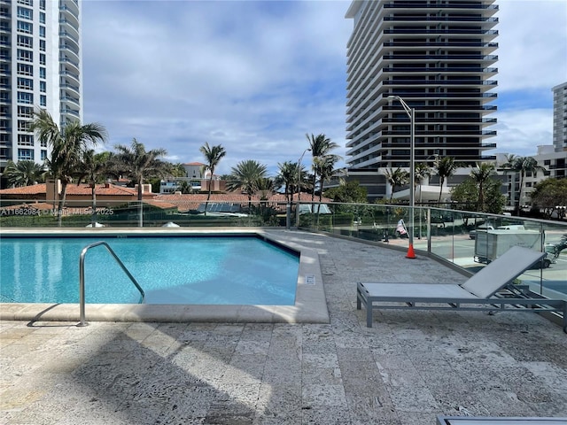 community pool featuring a patio area and fence