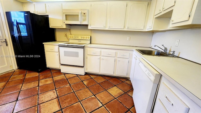 kitchen with white appliances, sink, and white cabinets