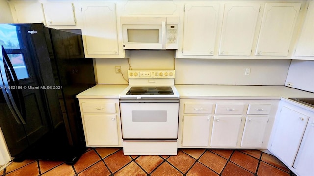 kitchen featuring white cabinets and white appliances