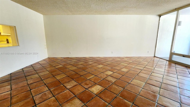 unfurnished room with a textured ceiling