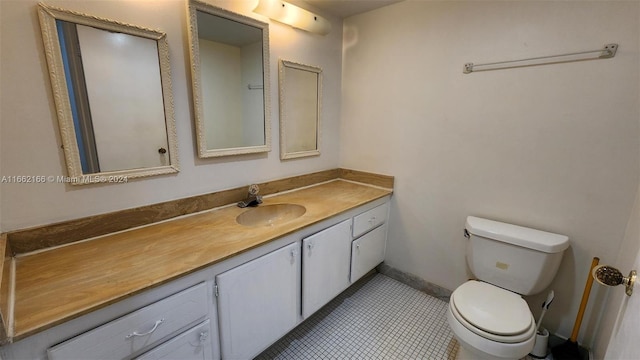 bathroom with tile patterned floors, vanity, and toilet