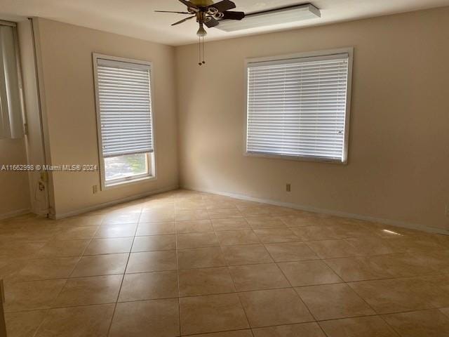 tiled empty room with ceiling fan