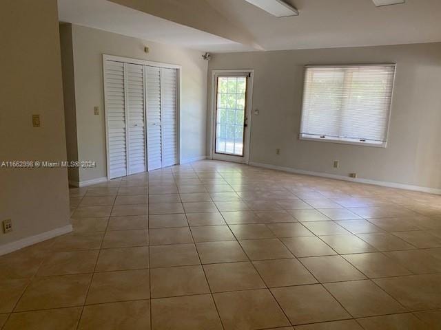 spare room featuring light tile patterned floors