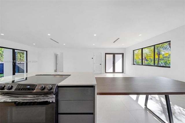 kitchen featuring electric stove and a healthy amount of sunlight