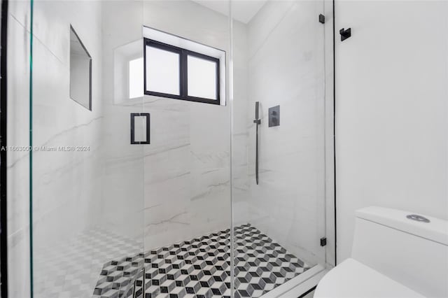 bathroom with walk in shower and toilet