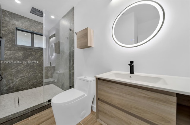 bathroom featuring hardwood / wood-style flooring, vanity, toilet, and an enclosed shower