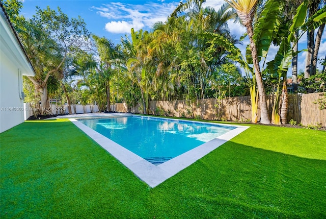 view of pool featuring a yard