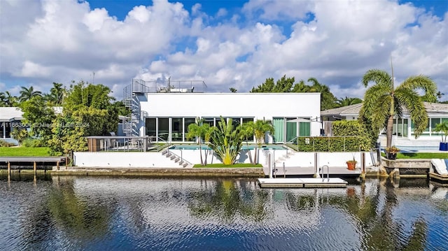 2112 NE 17th Ave, Wilton Manors, FL 33305 - back of house with a water view, an outdoor pool, a patio area, and fence