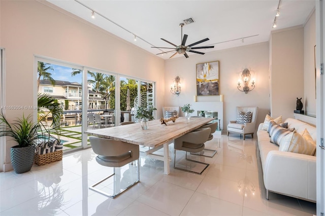 2112 NE 17th Ave, Wilton Manors, FL 33305 - dining area featuring light tile patterned floors, a ceiling fan, rail lighting, and visible vents