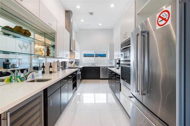 2112 NE 17th Ave, Wilton Manors, FL 33305 - kitchen with wine cooler, light tile patterned flooring, high quality appliances, light countertops, and a sink