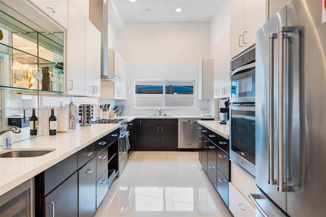 2112 NE 17th Ave, Wilton Manors, FL 33305 - kitchen with a sink, high end appliances, light tile patterned floors, and light countertops