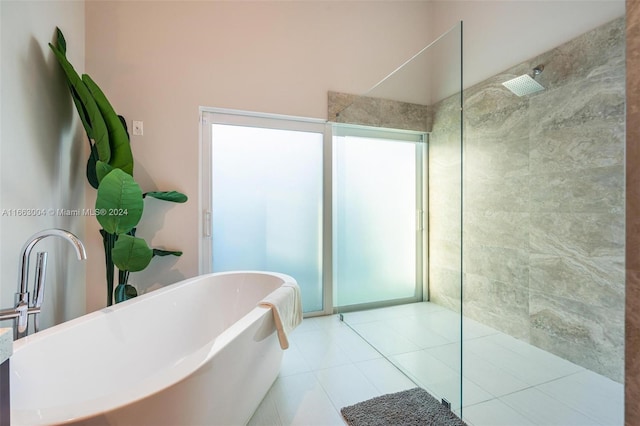 2112 NE 17th Ave, Wilton Manors, FL 33305 - bathroom featuring tile patterned flooring, walk in shower, and a soaking tub