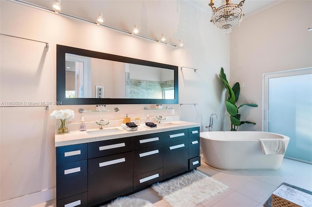 2112 NE 17th Ave, Wilton Manors, FL 33305 - bathroom with double vanity, a freestanding bath, a sink, tile patterned floors, and an inviting chandelier