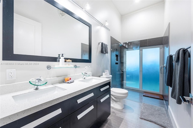 2112 NE 17th Ave, Wilton Manors, FL 33305 - bathroom with double vanity, a sink, a tile shower, and toilet