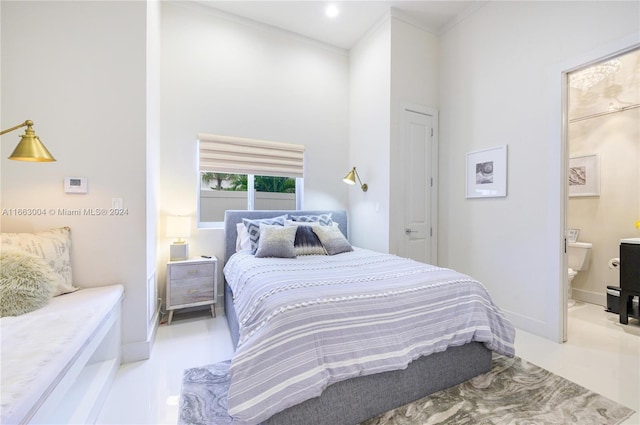 2112 NE 17th Ave, Wilton Manors, FL 33305 - bedroom featuring crown molding, a high ceiling, baseboards, and ensuite bath