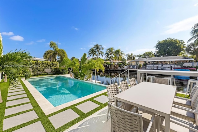 2112 NE 17th Ave, Wilton Manors, FL 33305 - view of pool with a fenced in pool, a water view, a patio, and outdoor dining space