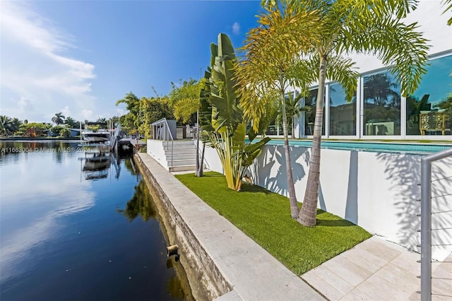 2112 NE 17th Ave, Wilton Manors, FL 33305 - view of dock with a lawn, a water view, and a community pool