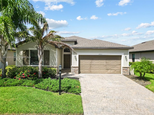 view of front facade with a front yard and a garage