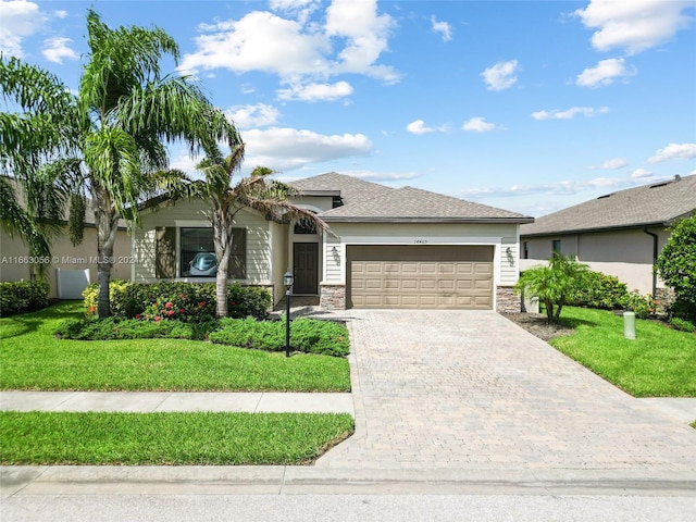 view of front of home featuring a garage and a front lawn