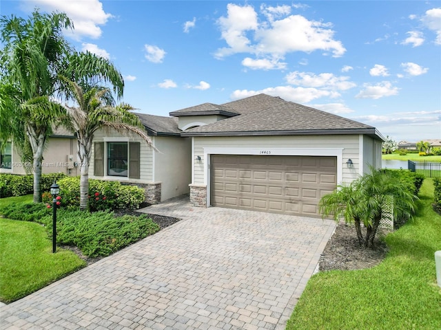 view of front of home with a front yard and a garage