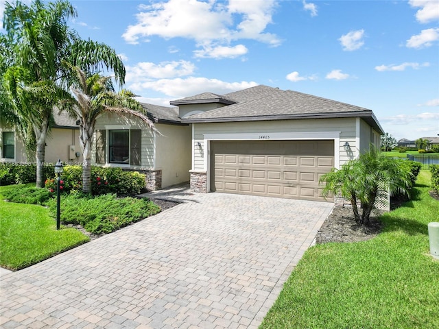 view of front of house with a garage and a front lawn