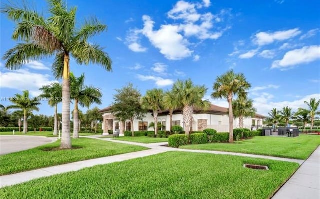 view of property's community with a lawn