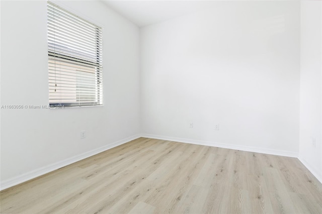 unfurnished room with light wood-type flooring