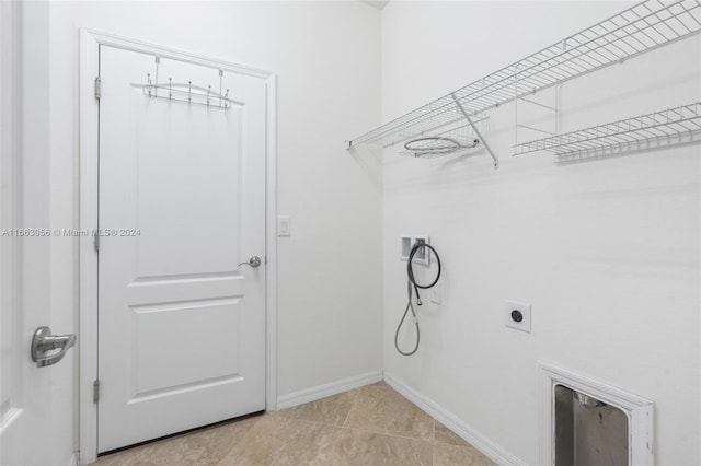 laundry room with light tile patterned flooring and hookup for an electric dryer